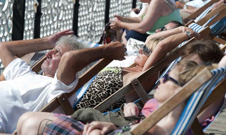 People relax in deckchairs in Brighton