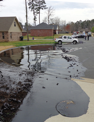 Click to enlarge Spilled oil coats the Northwoods subdivision