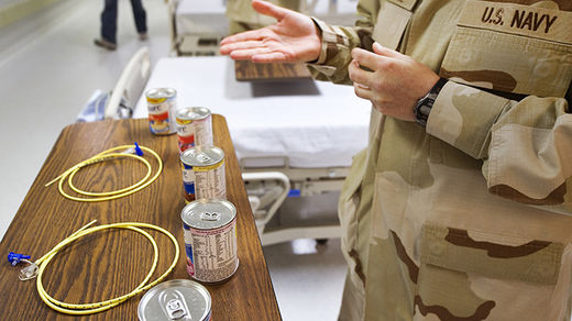  A US Navy doctor shows the feeding tubes