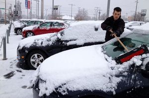 man shoveling car