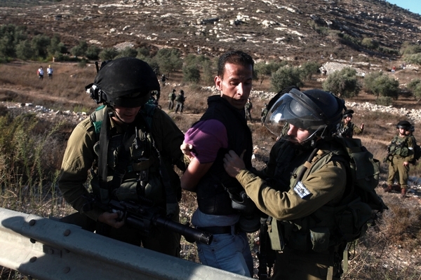 Israeli stomtroopers detaining palestinian