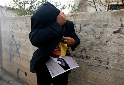 Click to enlarge protester against israeli settlements