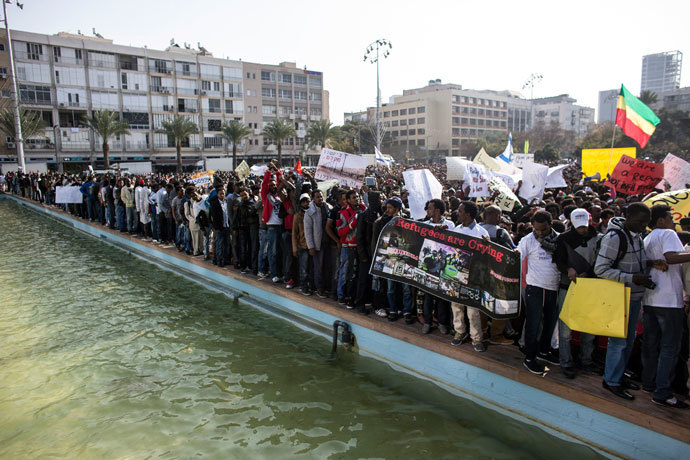 African migrants hold signs