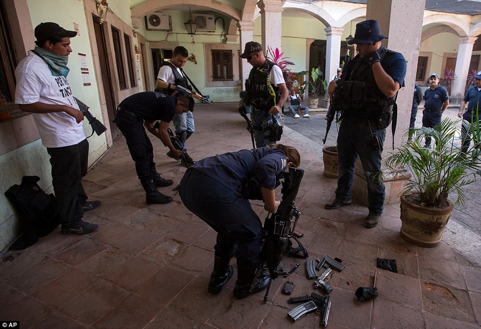 Police officers are forced to surrender their weapons 