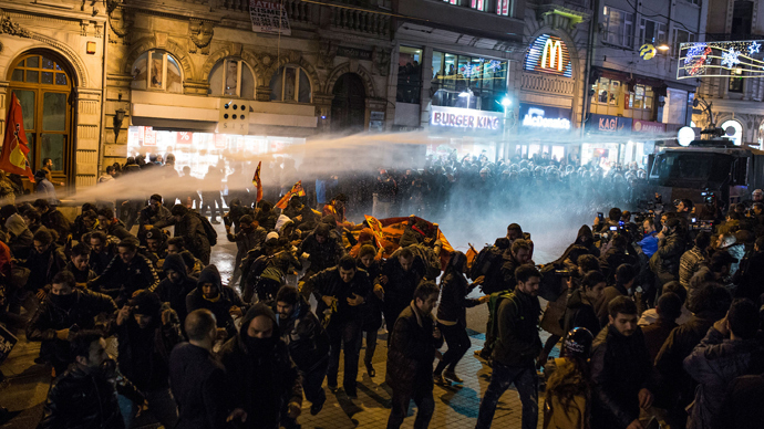 Click to enlarge Police use a water cannon