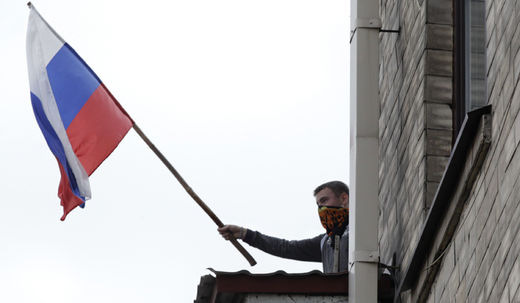 Ukrainian protester with Russian flag