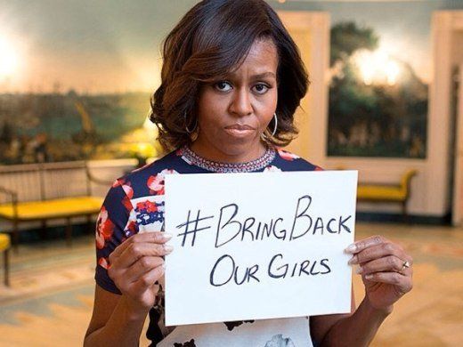 Click to enlarge Michele Obama and sign