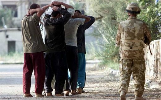 British soldiers take Iraqi prisoners in Basra.
