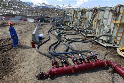 worker helps monitor water pumping pressure