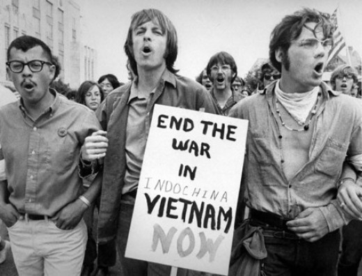 three students w end war in Vietnam sign