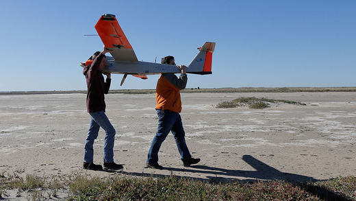 research team carry drone