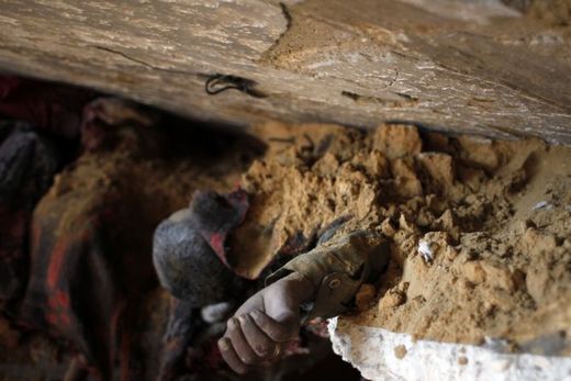Click to enlarge man buried in rubble