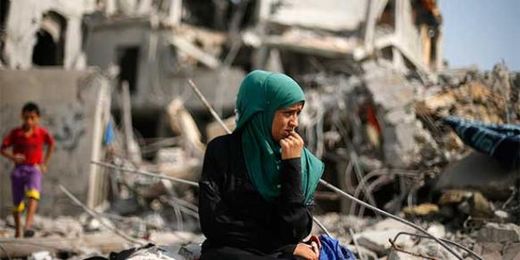 Click to enlarge woman surveys destruction